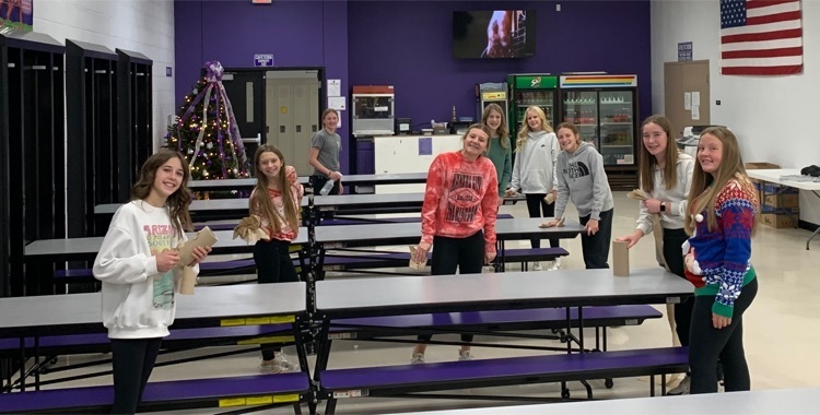 7th Grade girls helping in cafeteria.